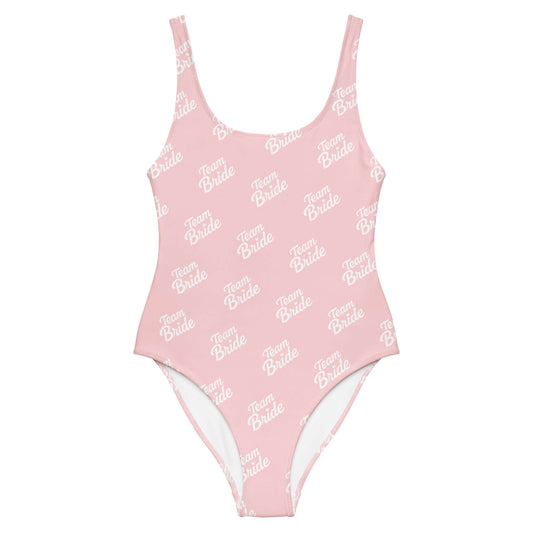 Costume da bagno intero rosa con scritta 'Team Bride' per addio al nubilato e momenti speciali.