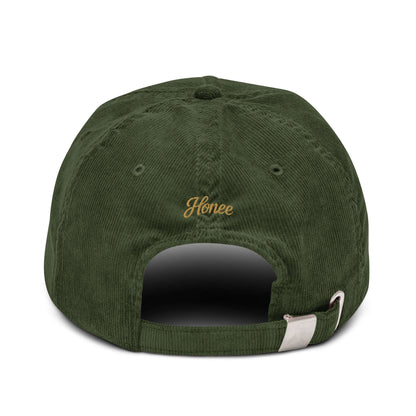 Back view of a green corduroy cap with embroidered text 'Honee' for a stylish accessory.