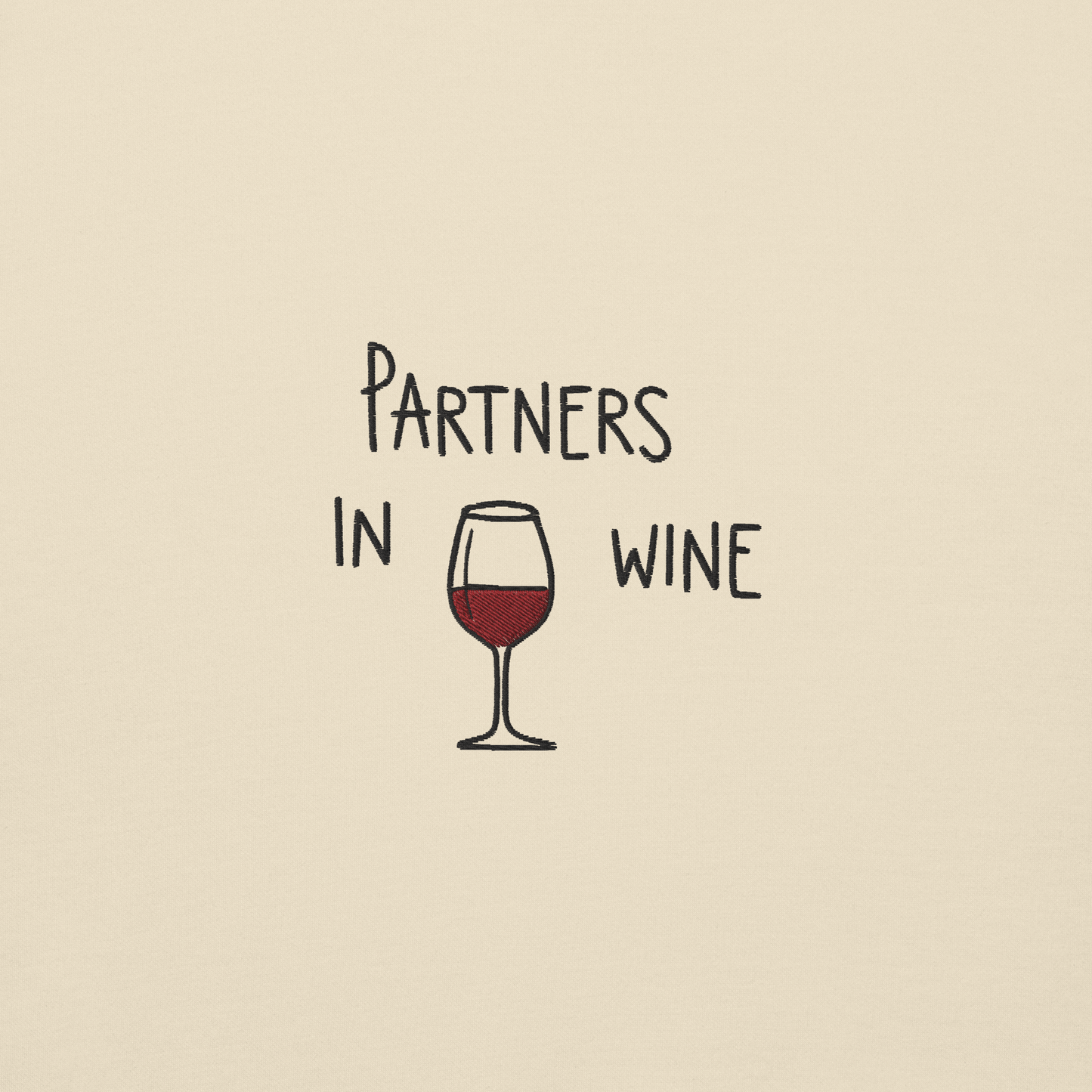 Ricamo con scritta 'Partners in Wine' e bicchiere di vino rosso su sfondo beige.