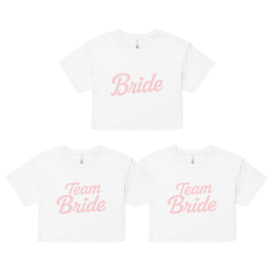 Set coordinato per addio al nubilato: crop top bianco con scritta rosa “Bride” per la sposa e due crop top abbinati con scritta “Team Bride” per le amiche.
